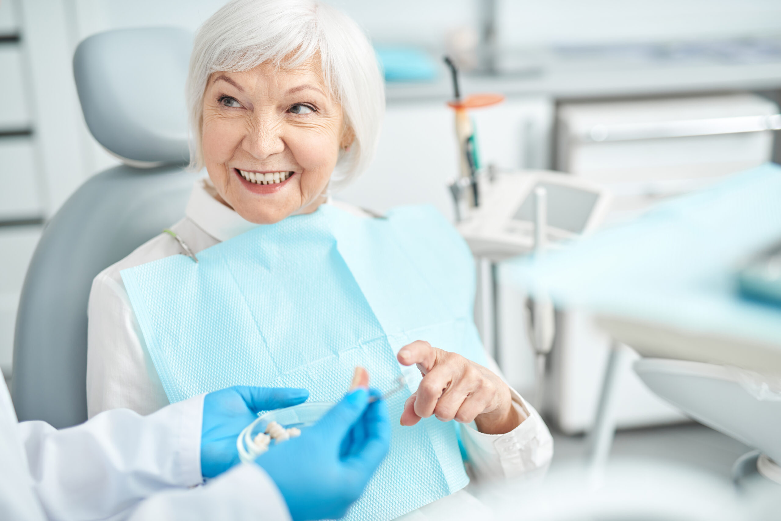 Smiling elderly woman looking at her doctor stock photo